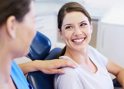 Woman in dental chair smiling