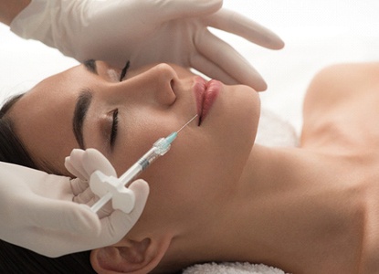 a patient receiving a BOTOX injection in their lip