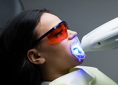 Patient receiving in-office teeth whitening treatment