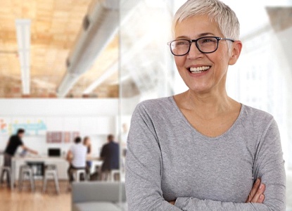 older woman crossing her arms and smiling