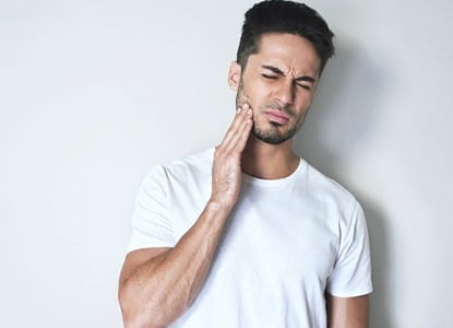 A young man with tooth pain.