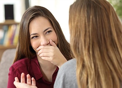 Woman covering her smile