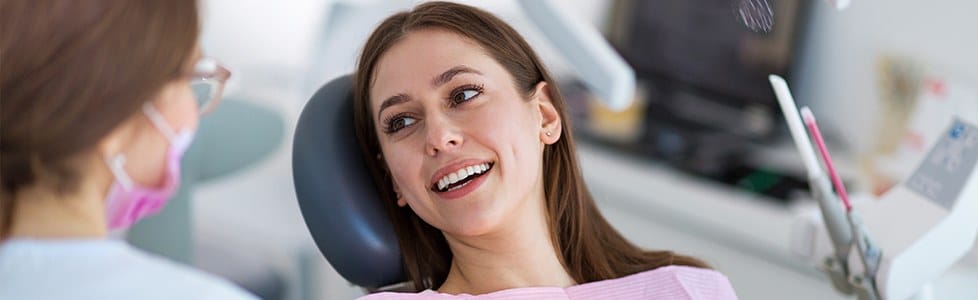 Woman in dental chair smiling