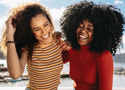 friends smiling and hanging out on a lake