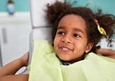 Smiling young girl in dental chair