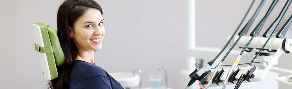 Woman in dental chair smiling